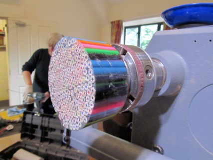 Pencils set in clear resin mounted on a screw chuck ready for turning